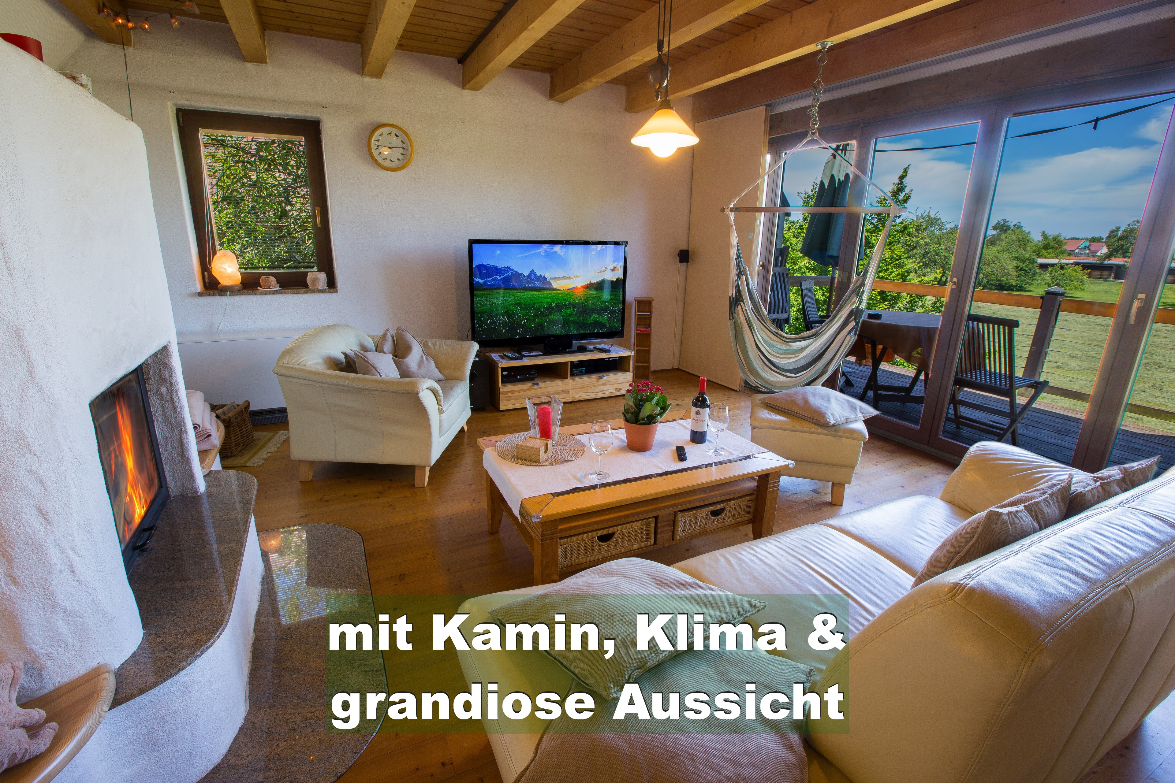 Living room with fireplace atmosphere and countryside view at Im Birkenweg